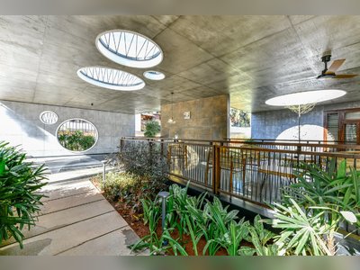 Circular Skylights Let the Landscape Grow Through This Concrete Home in India