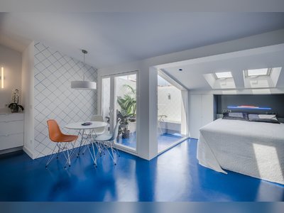 A Cramped Attic Apartment in Madrid Is Revived With Mirrored Walls and a Blue Floor