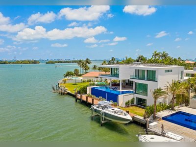 This 3-Story Residence With a Glass Elevator and Boat Lift in Miami