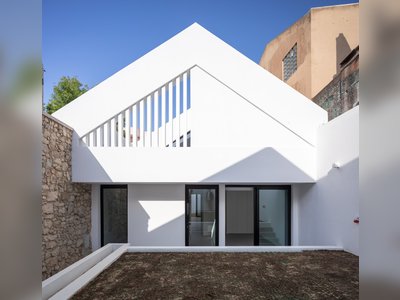An 18th-Century Sawmill in Portugal Is Revived as a Striking White Gable Home