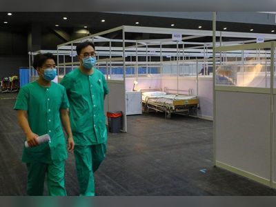 Hong Kong reports high of 14 new imported Omicron cases, braces for surge