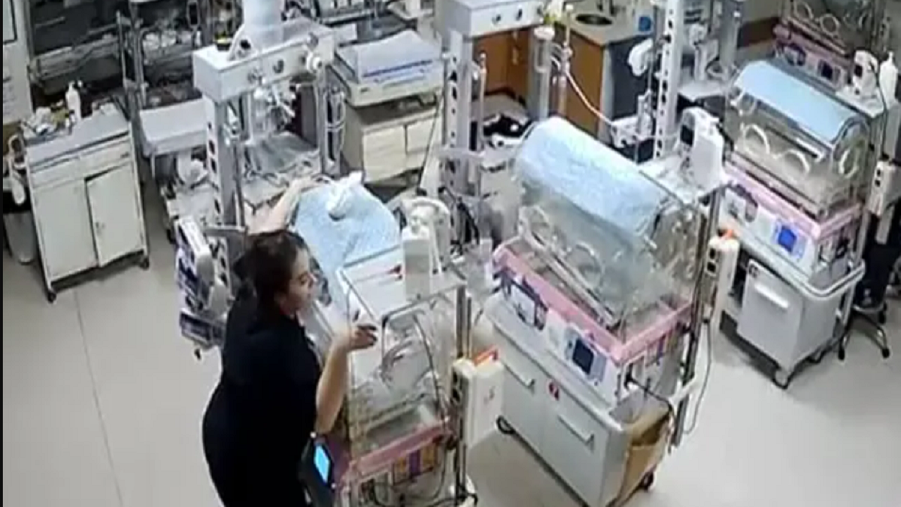 Nurses hold on to babies in incubators as quake hits