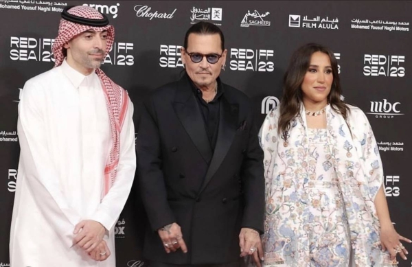 Johnny Depp with Jomana Al Rashid and Mohammed Al Turki at the red carpet as he arrives to the festival opening venue.